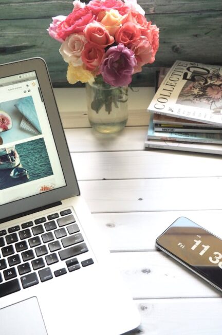 macbook-air-flower-bouquet-and-magazines-on-white-table